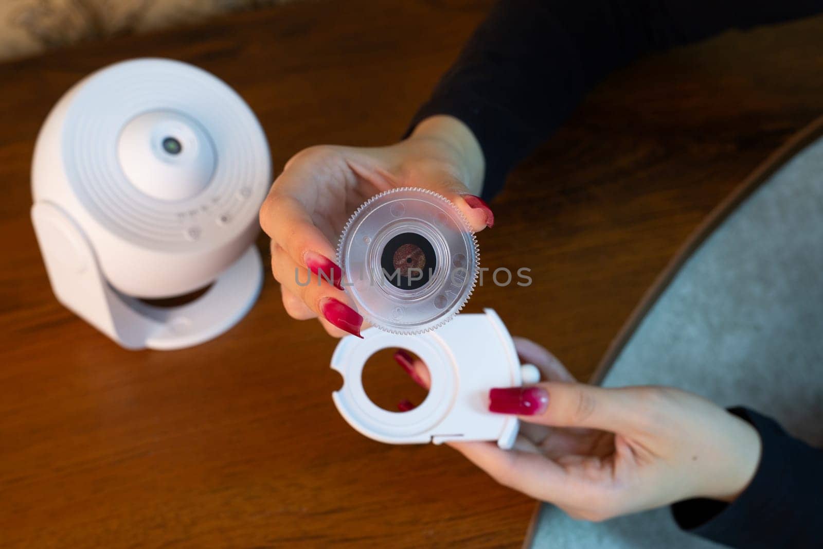Installing film disc in cartridge for galactic starry sky projector on the ceiling of room for exploring deep space, home planetarium using compact device for room