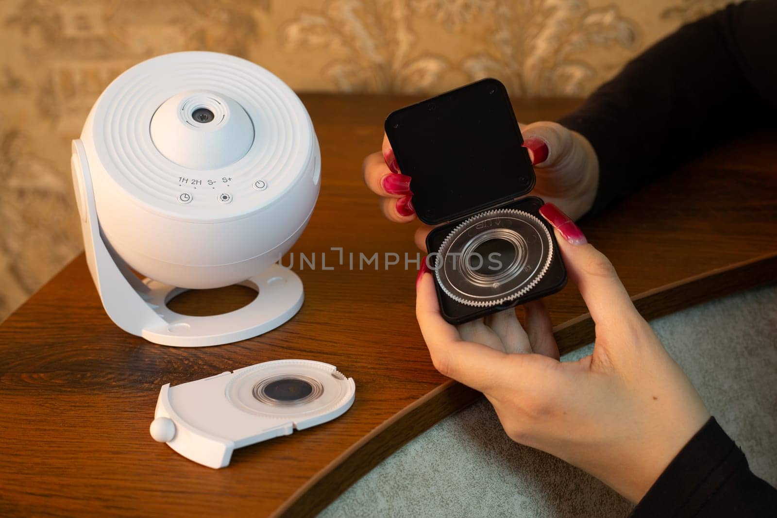 Choosing movie disc for space home projector, studying planets and stars at home using compact device for teaching in field of science and space