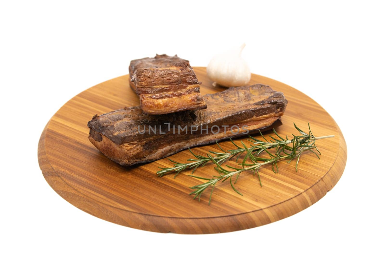 Delicious artisanal whole smoked slab bacon on a cutting block.