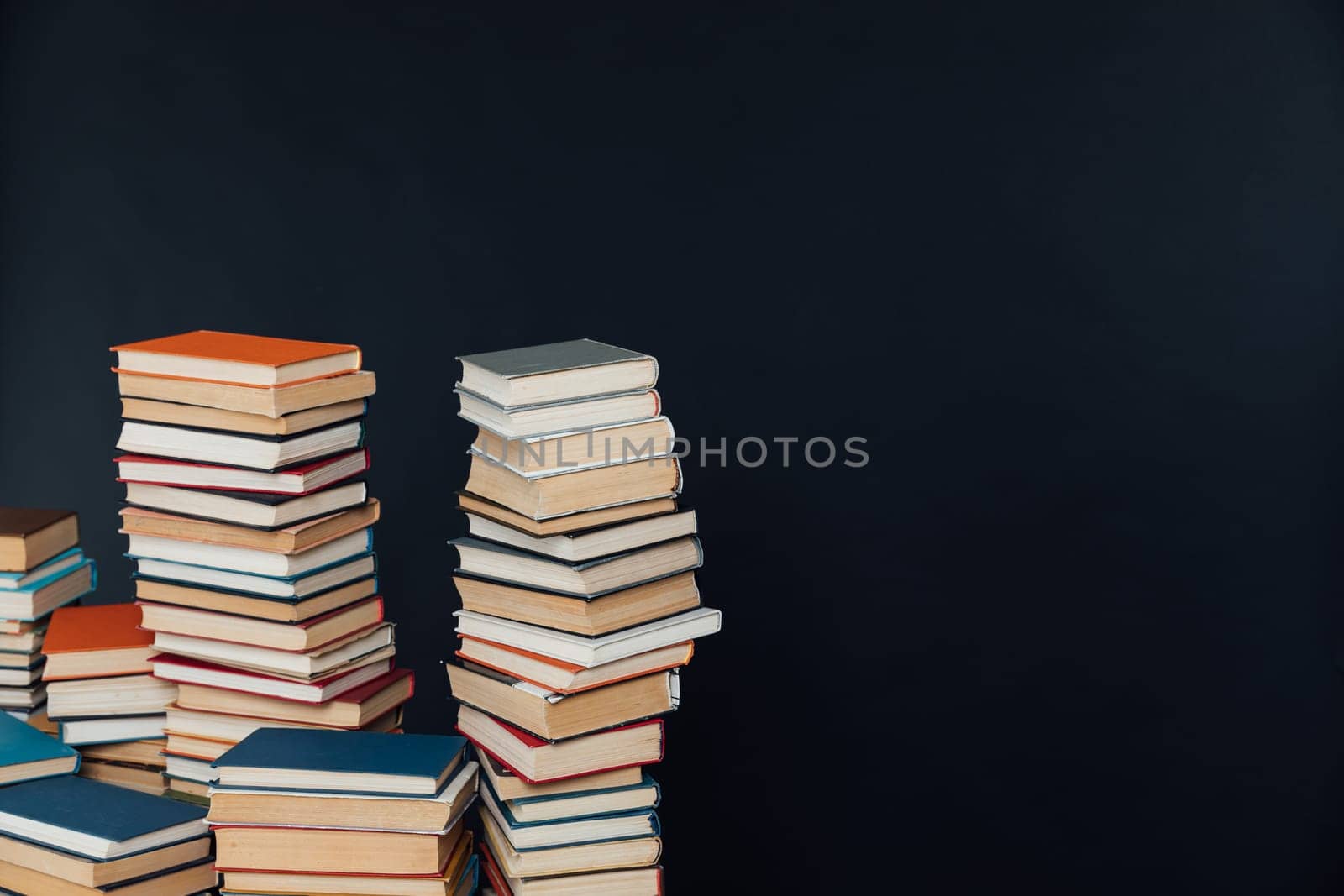 Stacks of books for studying in the university library as a black background