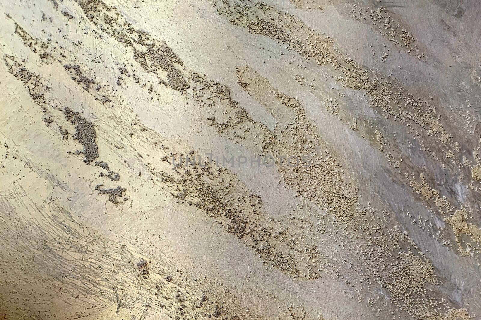 Golden texture of decorative Venetian plaster close-up
