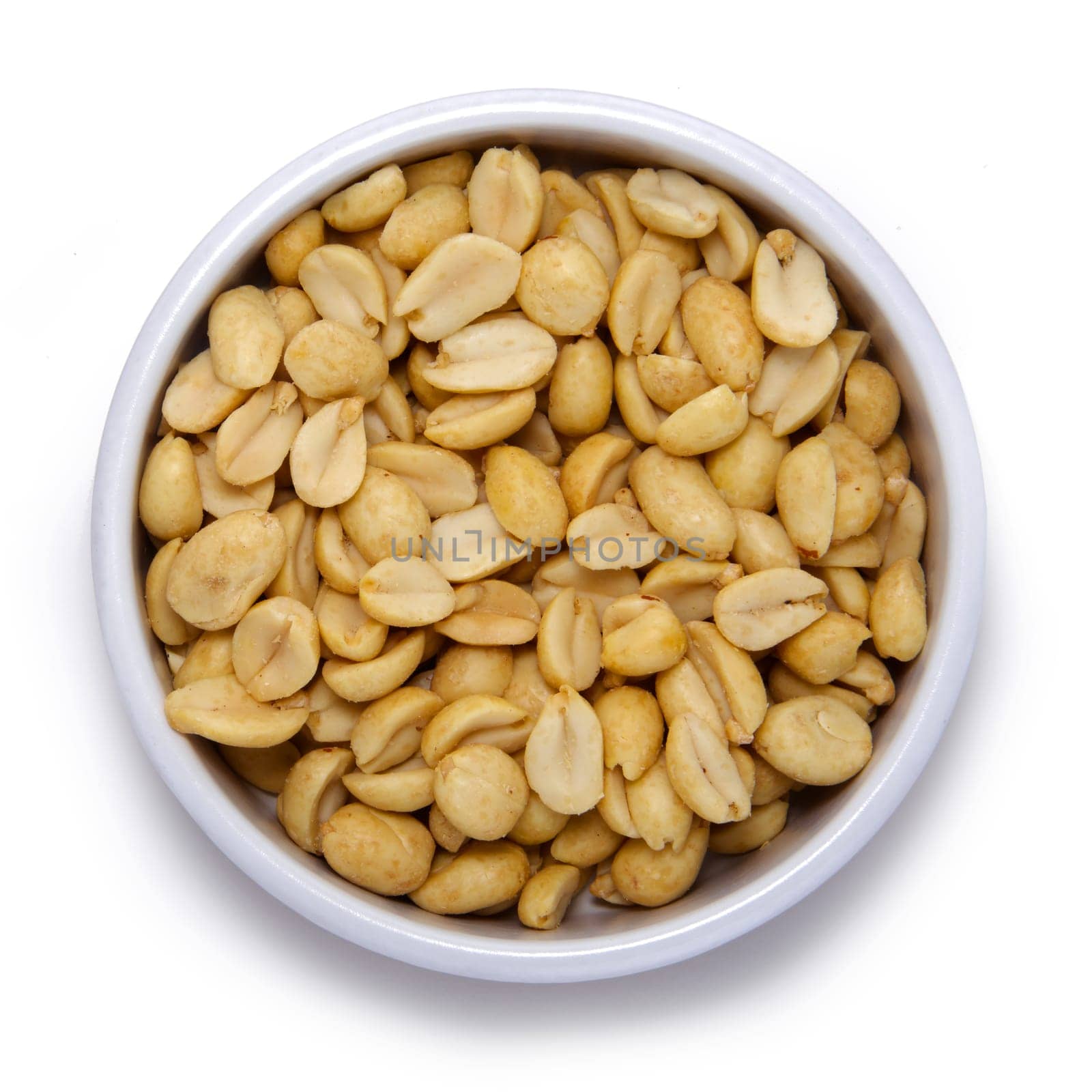 Roasted peanuts in round container on a white background