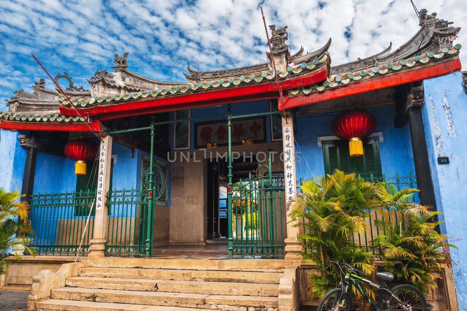 Asian gate to a Buddhist pagoda with a temple in the old town in Hoi An city in Vietnam in Asia