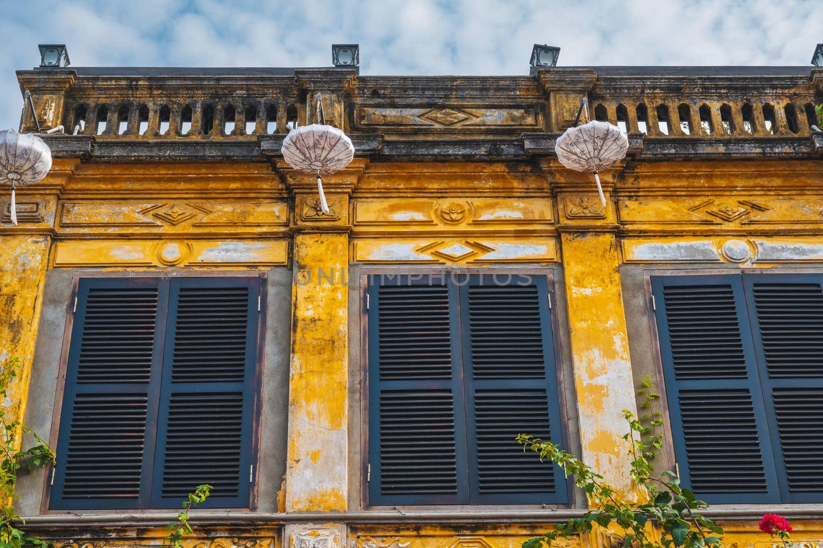 historical facade of an ancient Asian yellow house in the old town in Hoi An in Vietnam in Asia