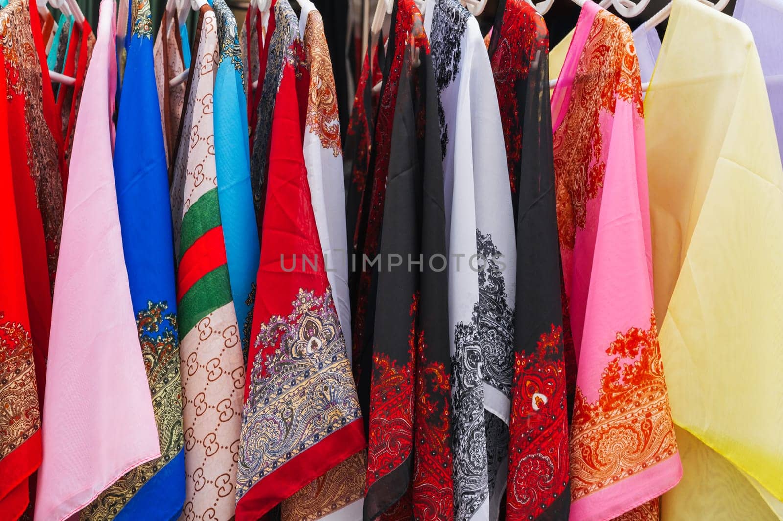 Traditional Asian multicolored silk dresses on the market in Asia in Vietnam