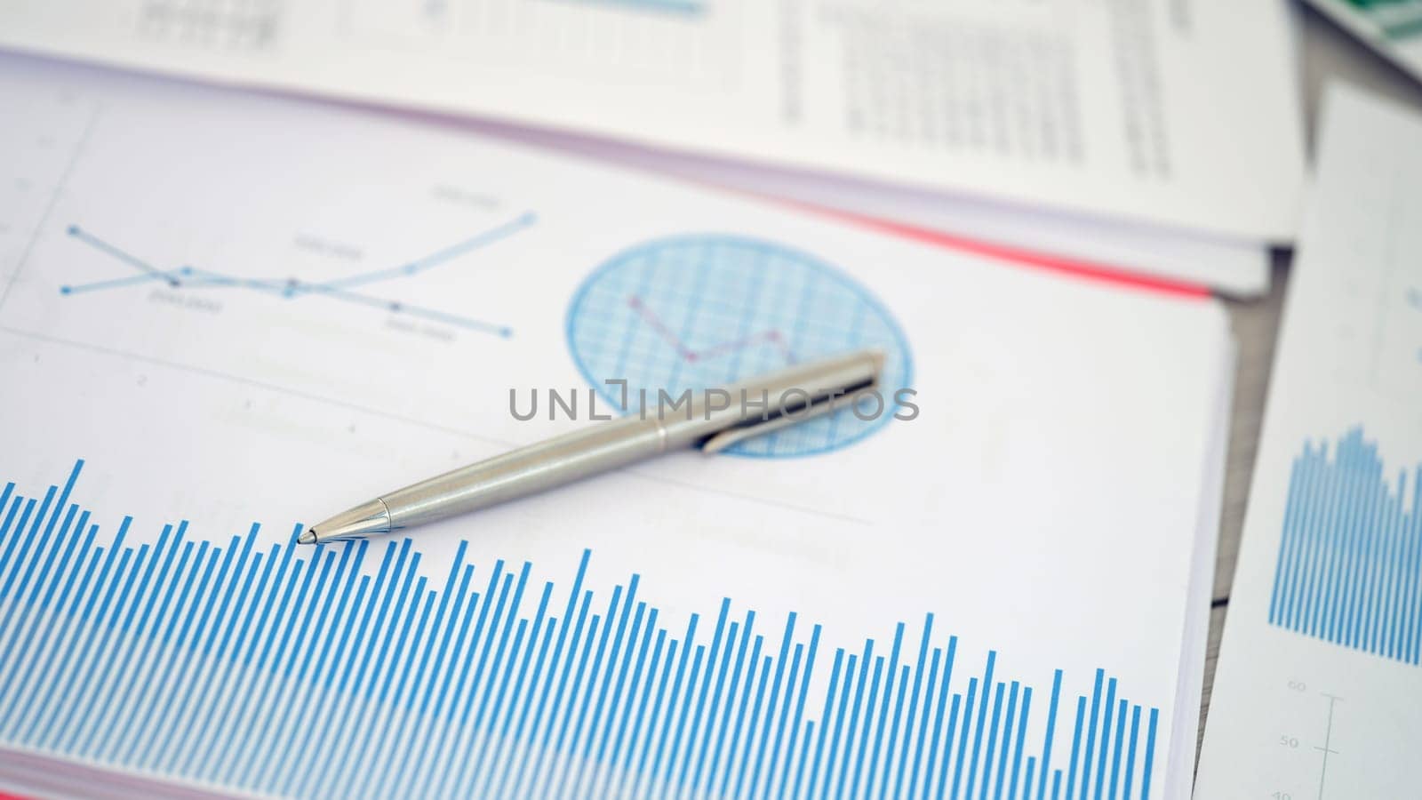Utilizing graphs and various statistics on financial documents alongside a pen aids in comprehensive analysis