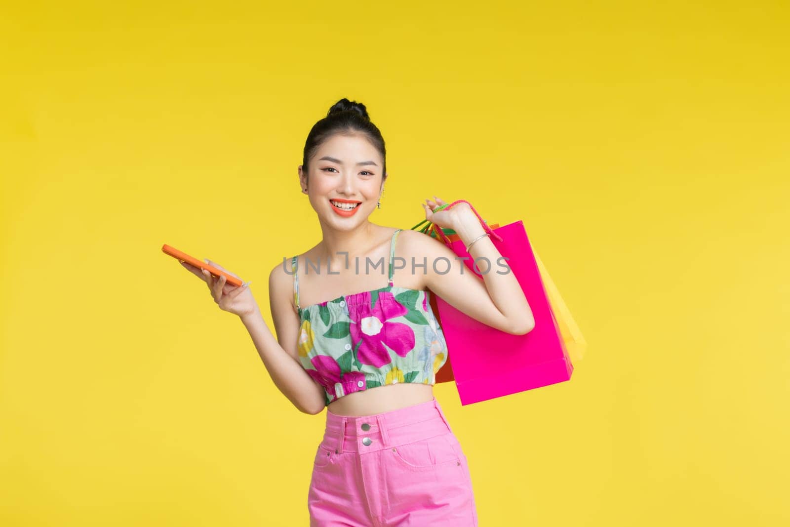 Women carrying a lot of colorful shopping bags and mobile phone,Selective focus