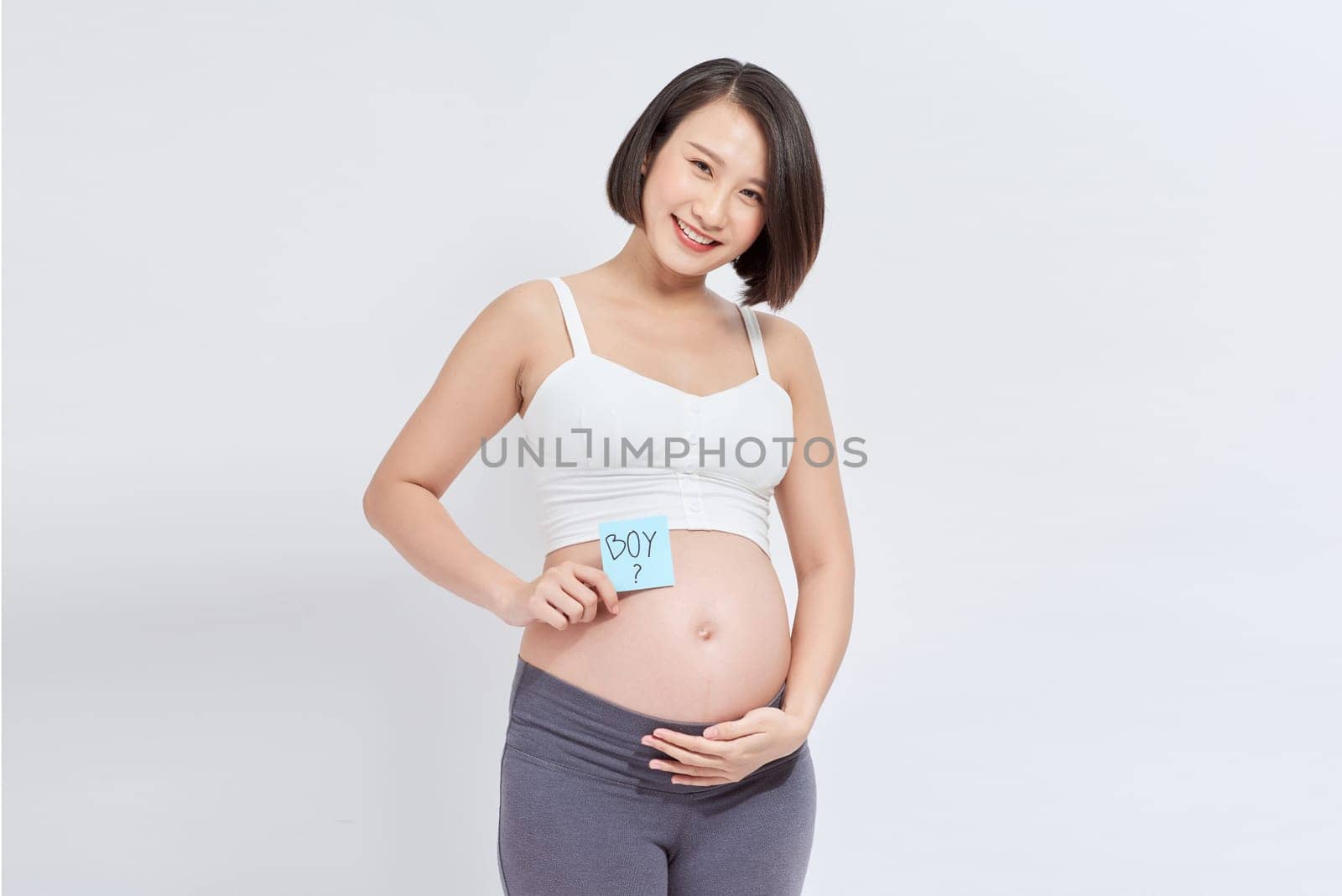 Pregnant woman with stick notes on her belly