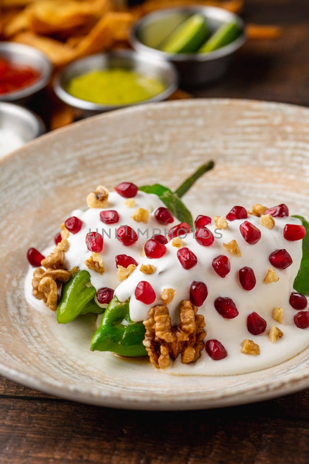 Chiles en Nogada, a traditional Mexican dish made with pablano chili stuffed with meat and fruit and garnished with pomegranate seeds and walnuts by Sonat