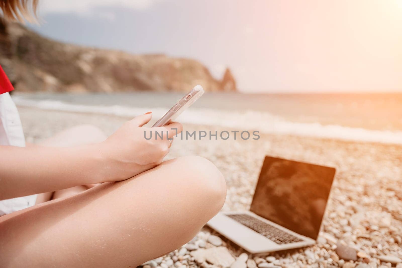 Woman sea laptop. Business woman in yellow hat working on laptop by sea. Close up on hands of pretty lady typing on computer outdoors summer day. Freelance, digital nomad, travel and holidays concept