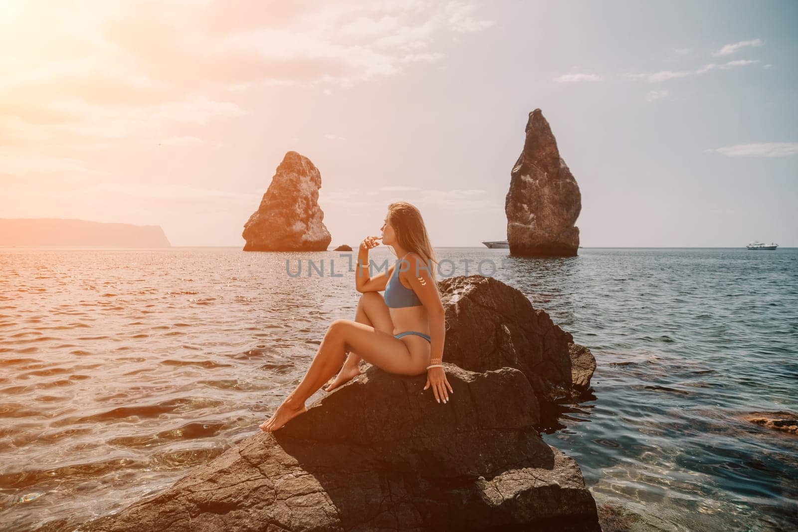 Woman summer travel sea. Happy tourist enjoy taking picture outdoors for memories. Woman traveler posing on the beach at sea surrounded by volcanic mountains, sharing travel adventure journey by panophotograph