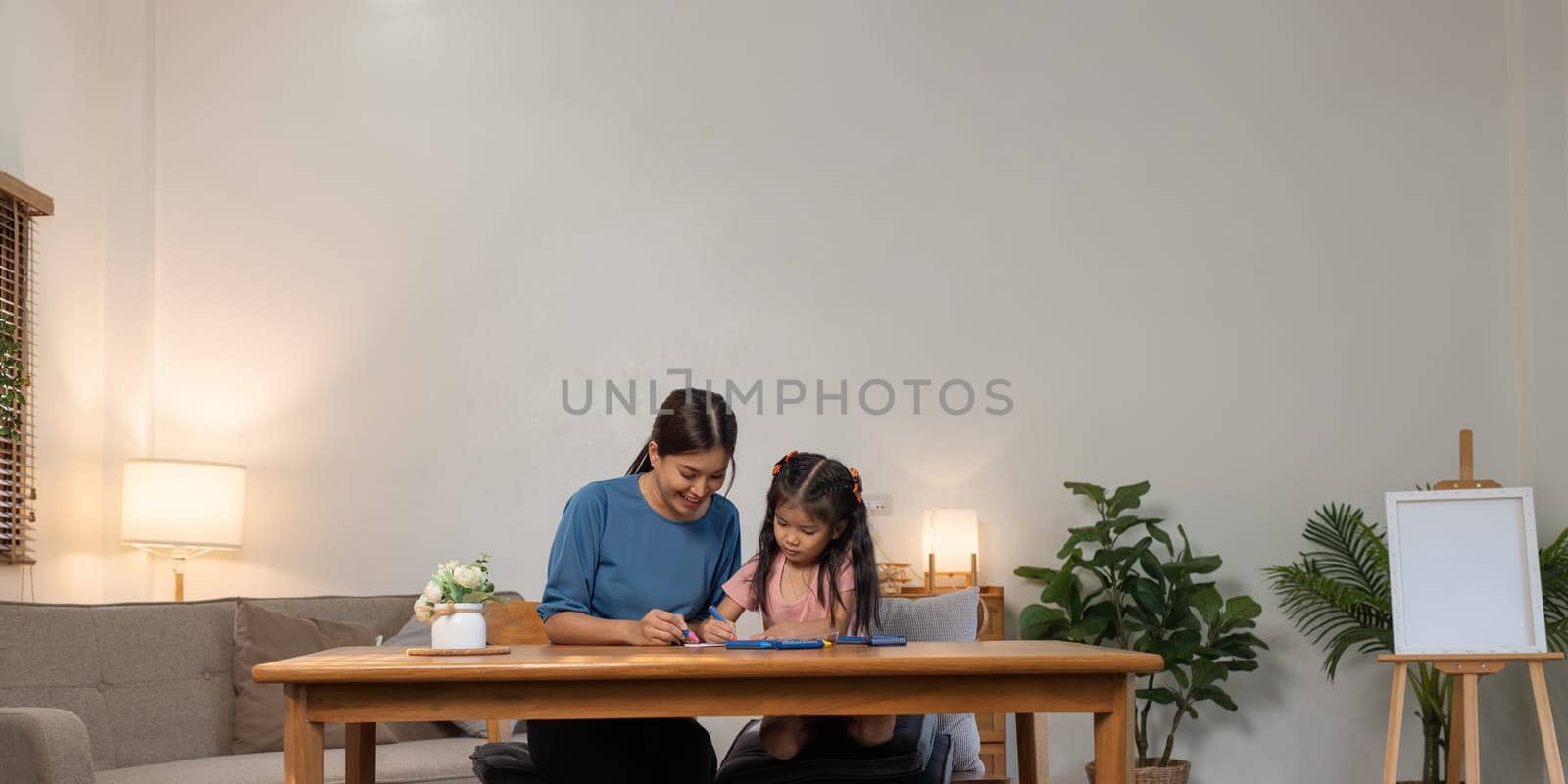 Mother and her daughter draw in the paper together, Leisure activities, holiday.