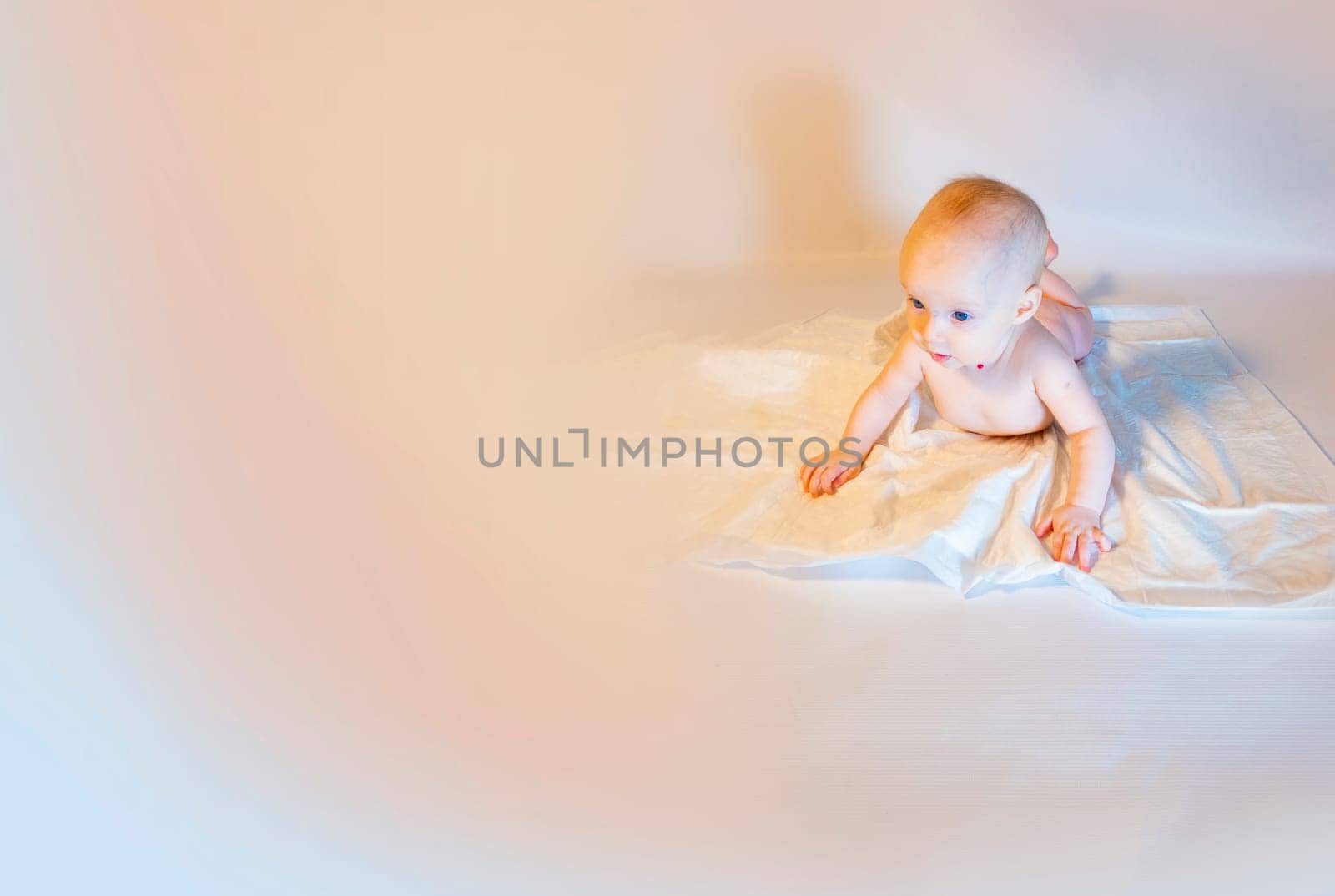 a baby with a hemangioma on his neck lies on a white background. banner with a copy space. a child on a disposable diaper. purity