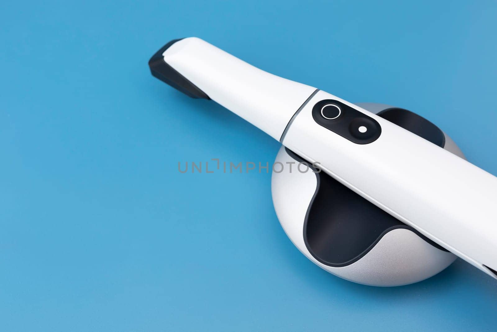 White 3d Intraoral Dental Tooth Scanner On Blue Background. Dental Equipment, Device For Scanning Teeth. Copy Space, Dentistry And Health Care Concept . Horizontal Flat Lay View