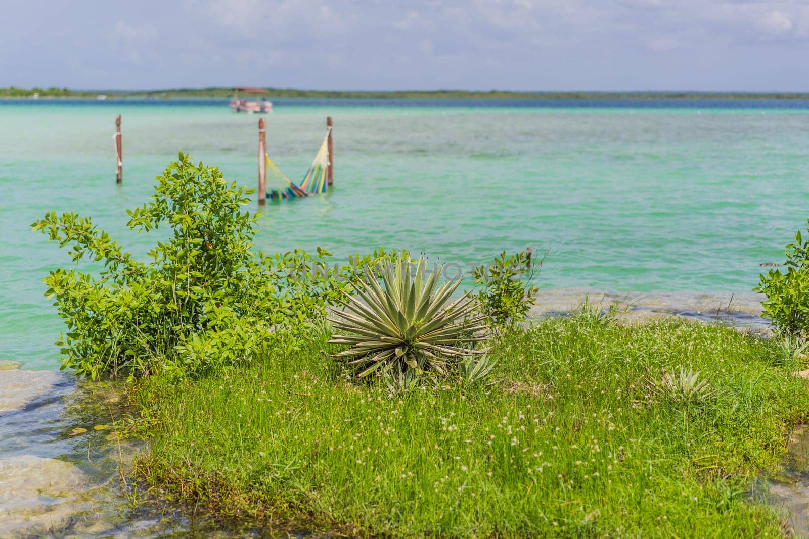 Turquoise waters of Bacalar Lake, Mexico. Peaceful and scenic tropical destination. Travel, relaxation, and nature concept.