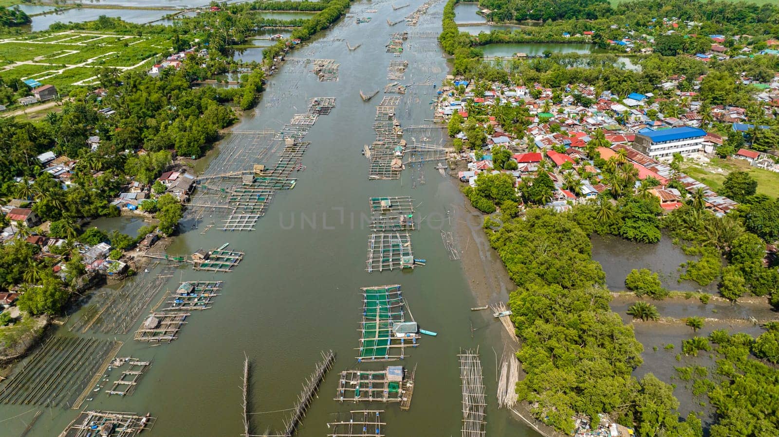 Village with a fish farm on the river. Hinigaran River. Negros, Philippines