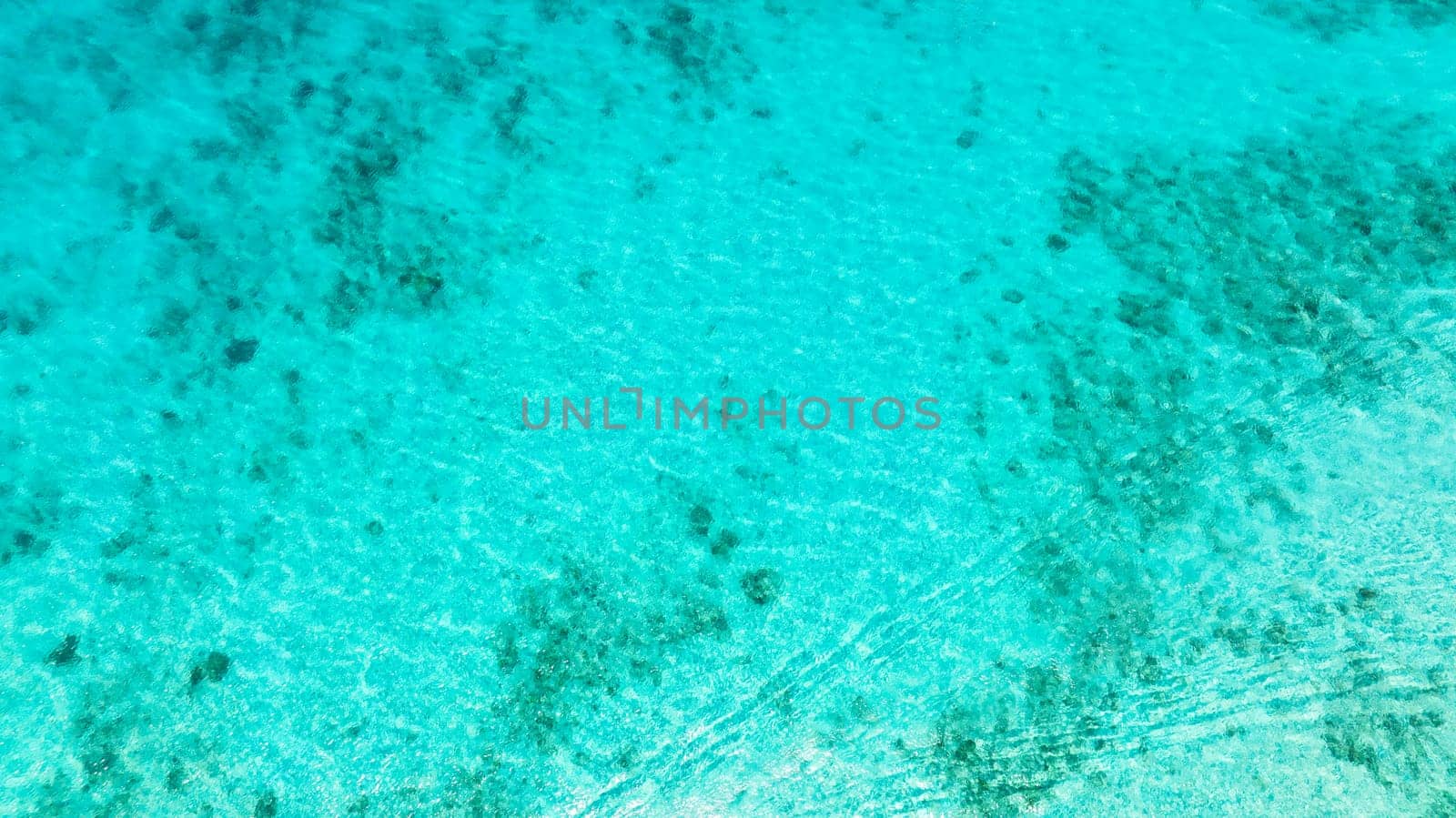 Top view transparent turquoise ocean water surface. Sea water surface in lagoon.