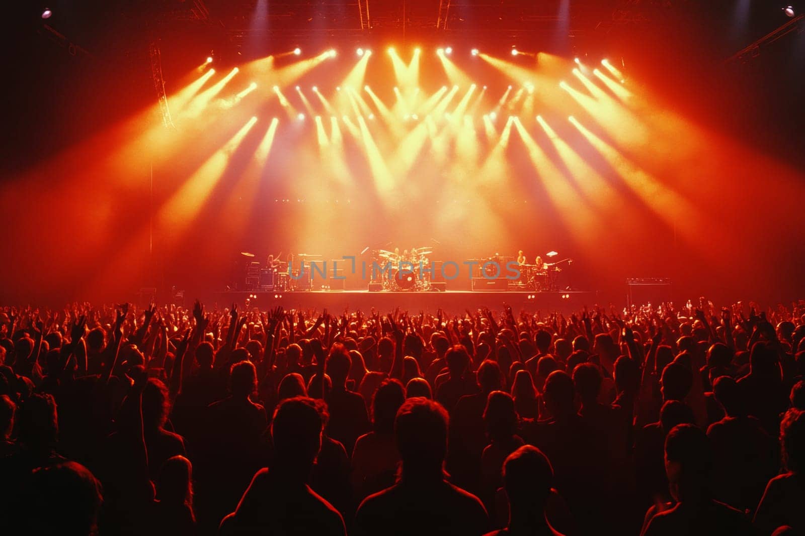 The stage during a concert is lit with bright red light and floodlights. High quality photo