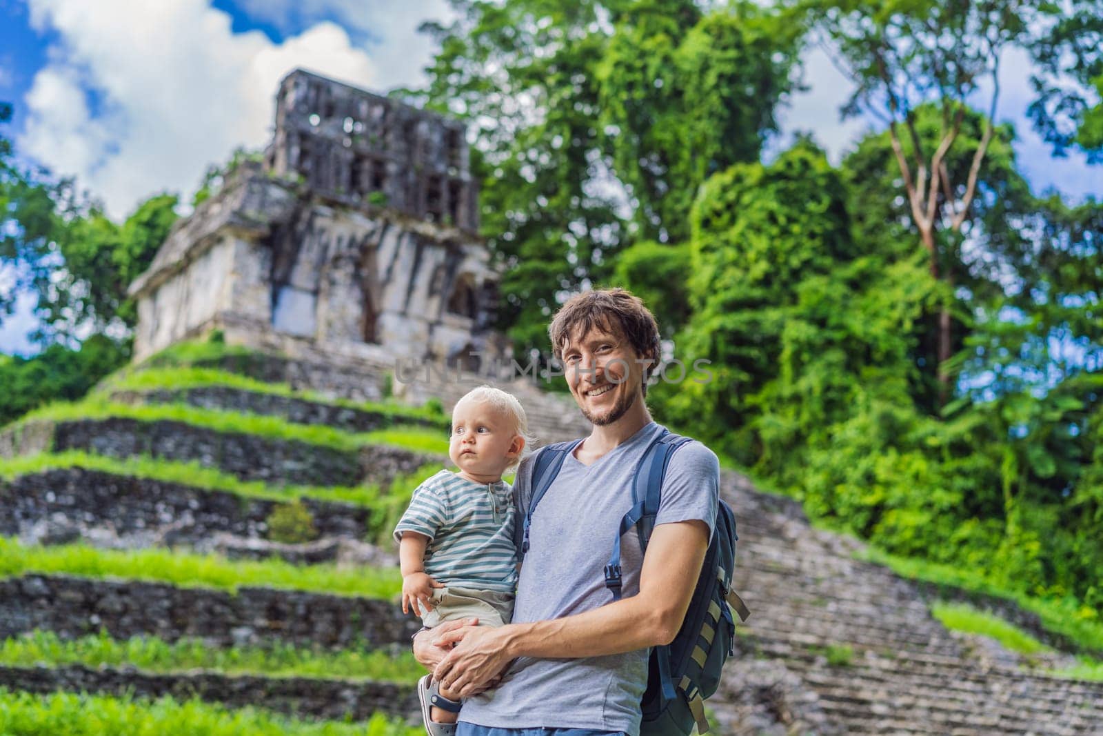 Mother with his toddler son exploring the ancient pyramids of Palenque, Mexico, surrounded by dense jungle. Cultural heritage and adventure travel concept.