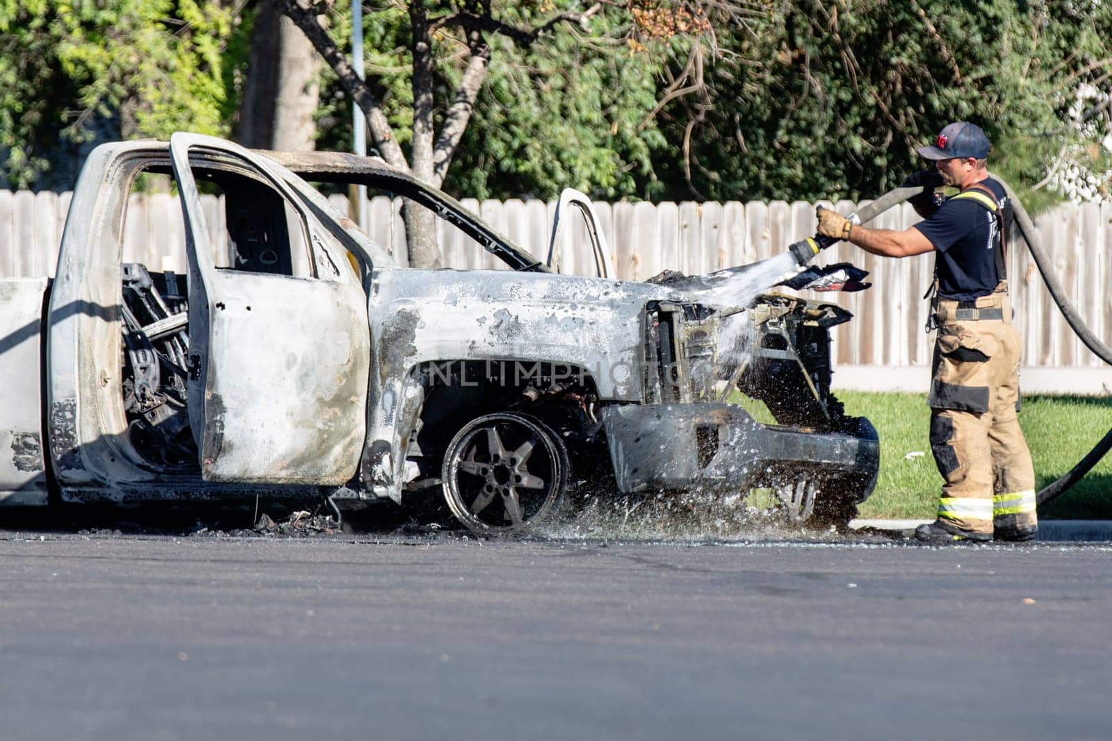 Nampa, Idaho - September 22, 2024: Firefighter putting out a truck that caught on fire at a local gas station