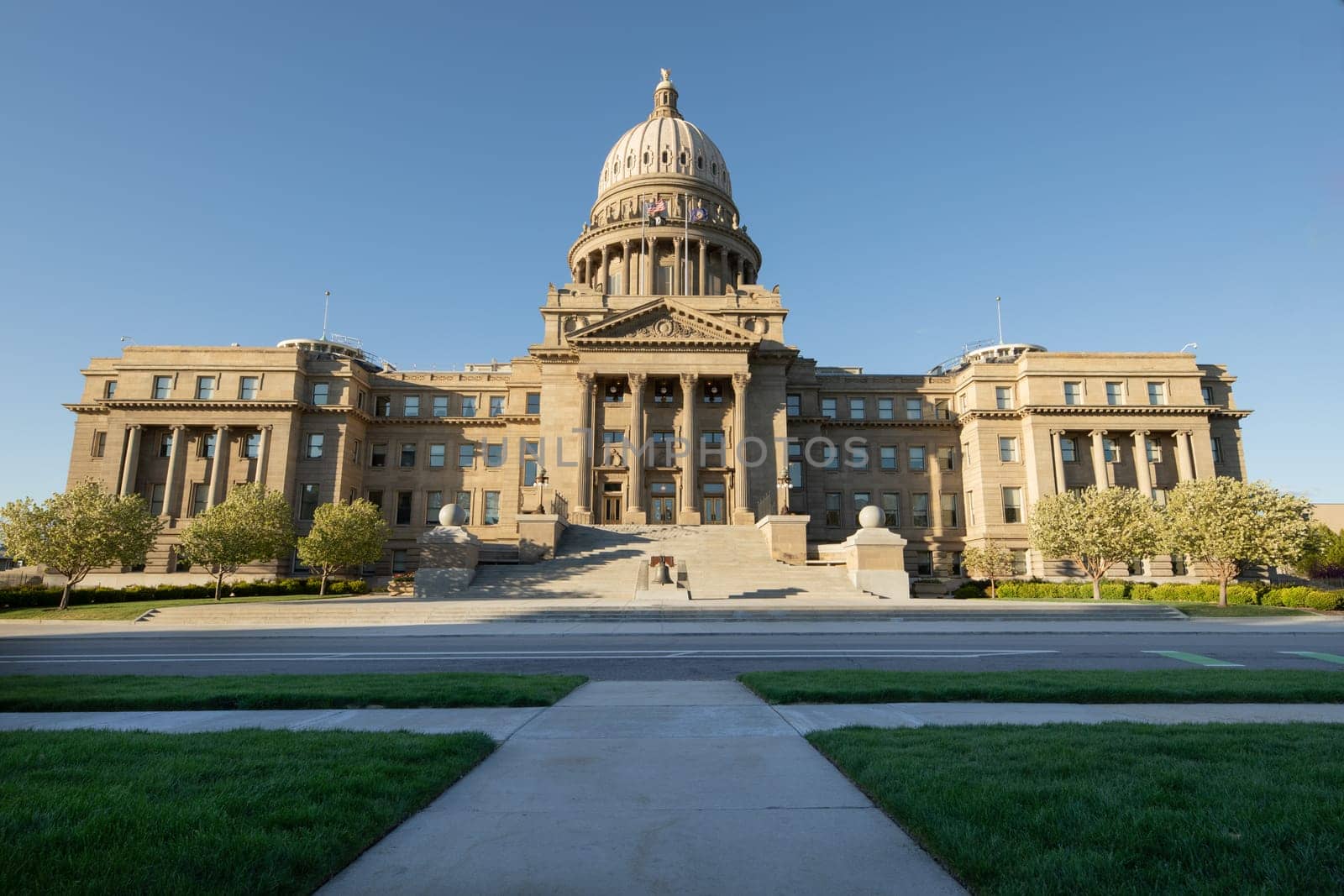 Majestic view of the State Capitol Building in Boise, showcasing its grand architecture under a clear blue sky. Captures the essence of government and history in Idaho.