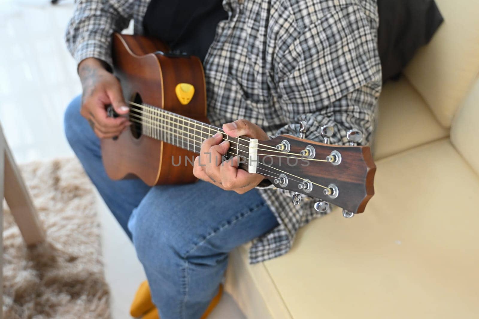 Close up of man playing acoustic guitar. Leisure activity and hobby concept.