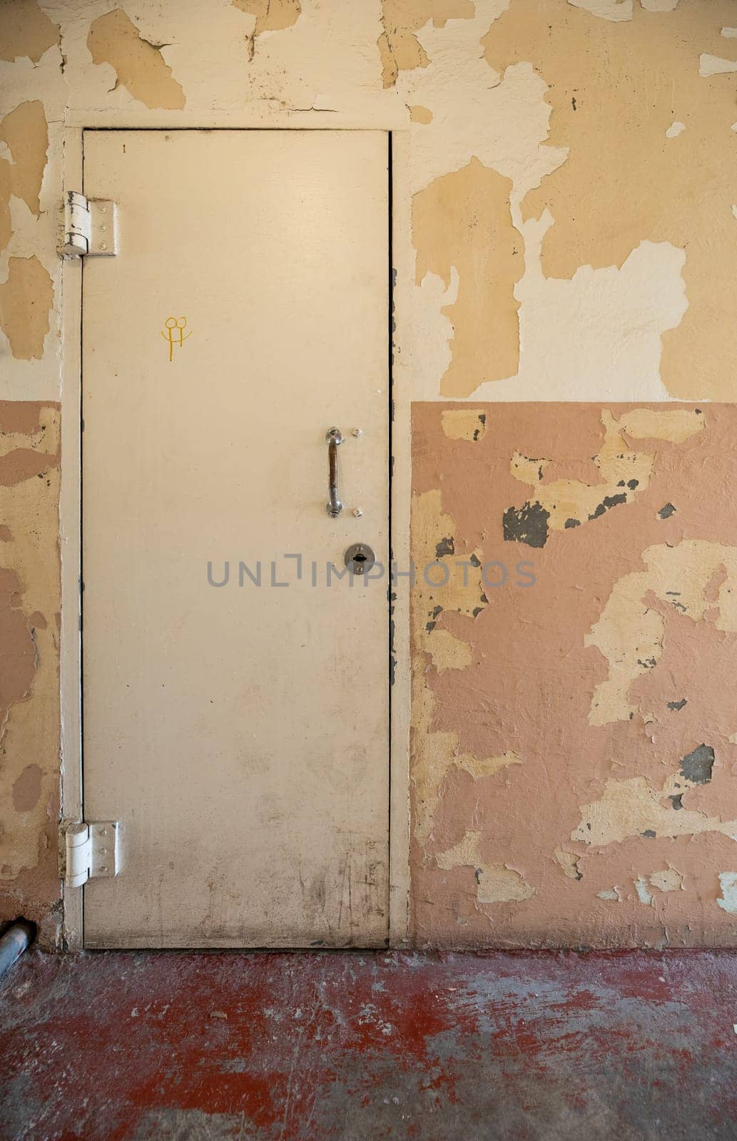 A vintage door with peeling paint, showing aged and rustic charm. Perfect for themes of decay, history, and urban exploration.
