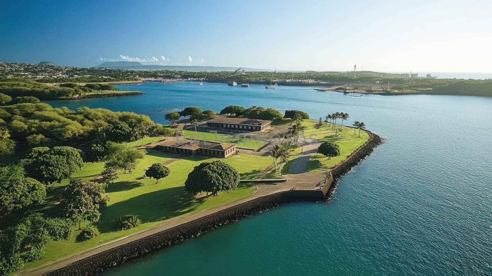 Aerial view of fort derussy on a sunny day, showcasing the lush greenery and the sparkling waters of honolulu harbor