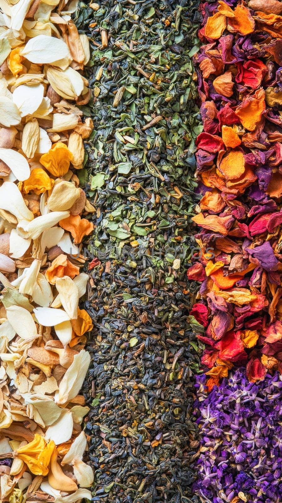 Colorful background is forming by dried flowers and tea leaves