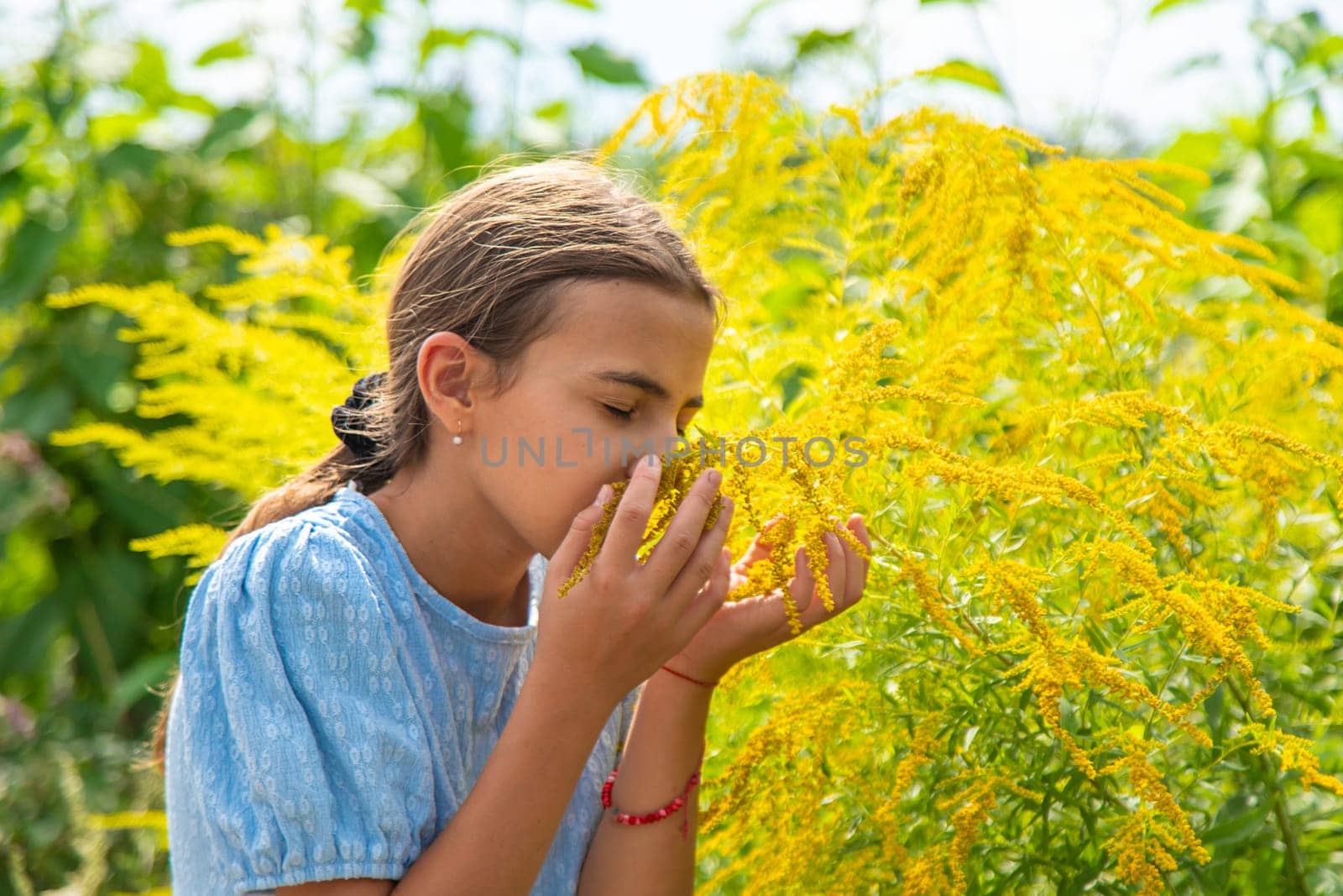 Child in ragweed flowers allergy. Selective focus. Kid.