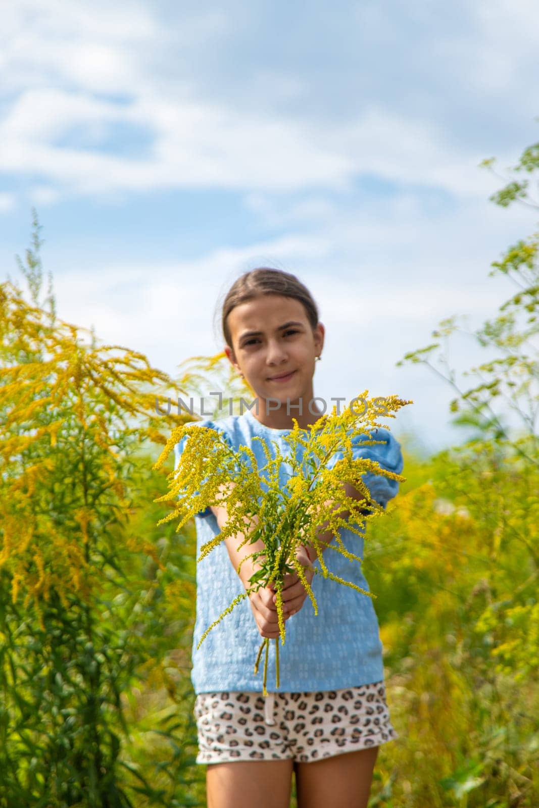 Child in ragweed flowers allergy. Selective focus. Kid.