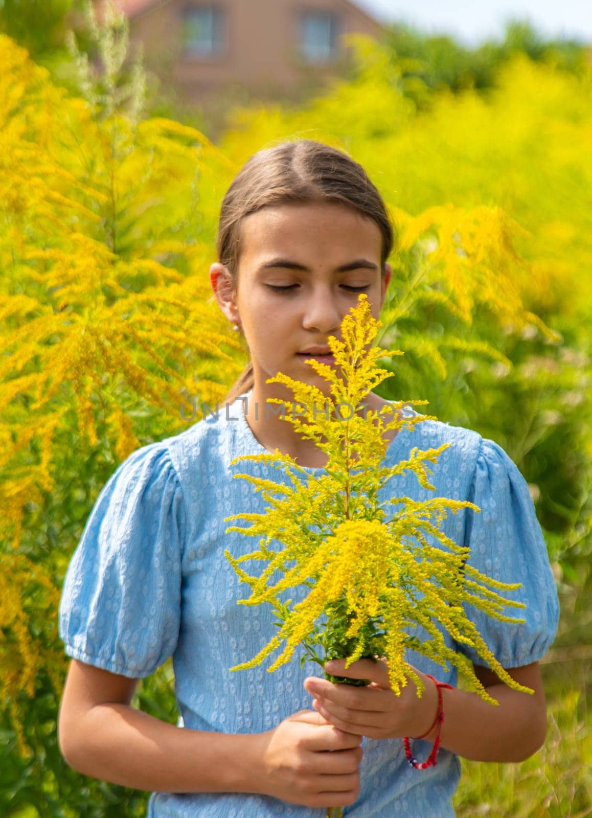 Child in ragweed flowers allergy. Selective focus. Kid.