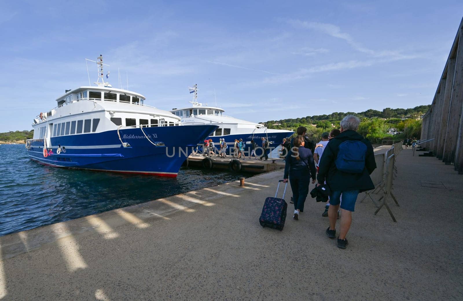 Porquerolles, France - June 14 2024: Passenger ferry between Hyeres and Porquerolles island making an arrival maneuver. High quality photo