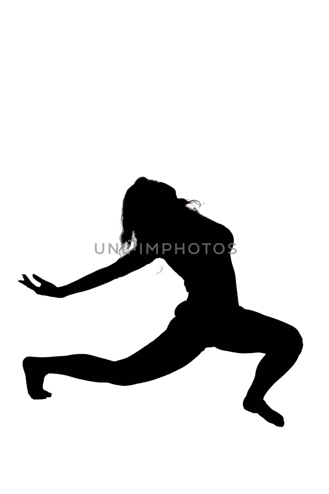 A beautiful silhouette of a woman gracefully stretching her legs against a bright white background, showcasing her form and movement