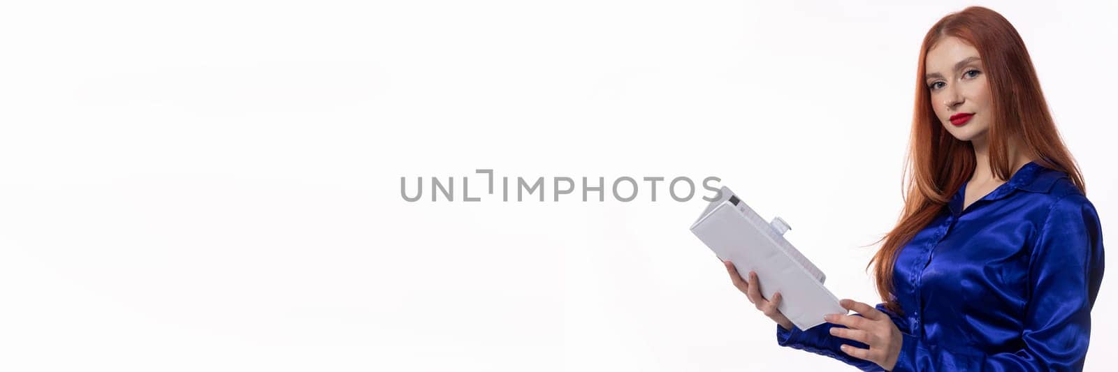 A confident woman in blue attire, holding documents, perfect for business and professionalism themes.