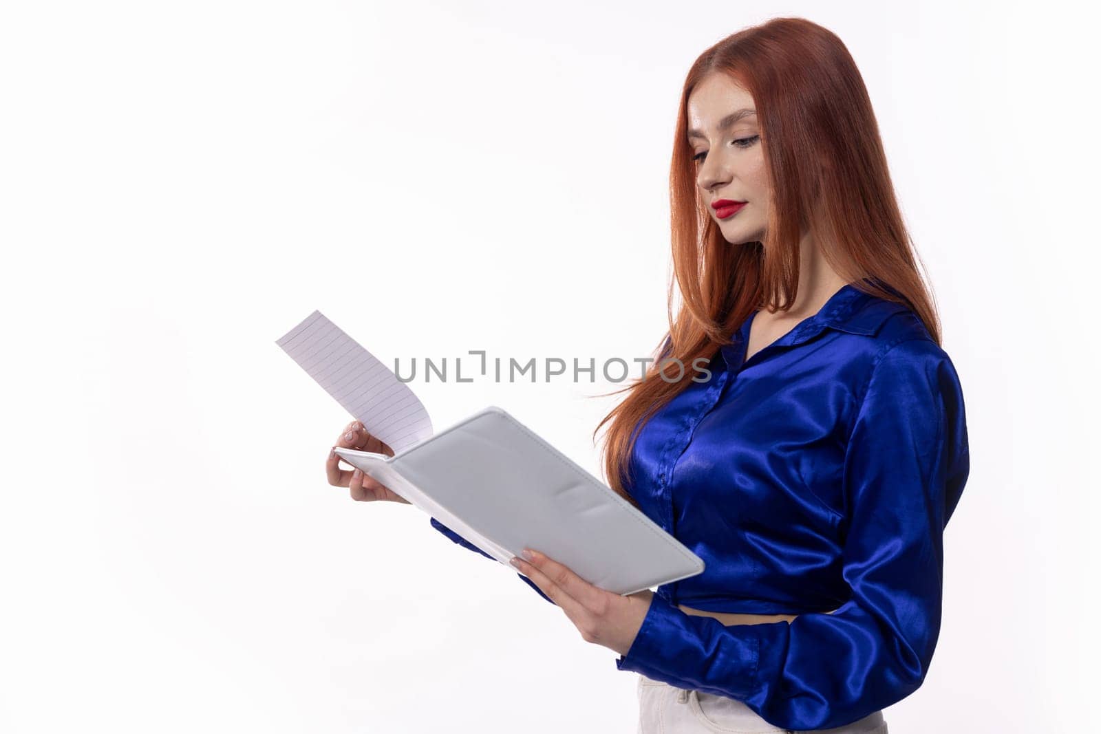 A focused professional woman reading important documents in a sleek, modern office that boosts her productivity