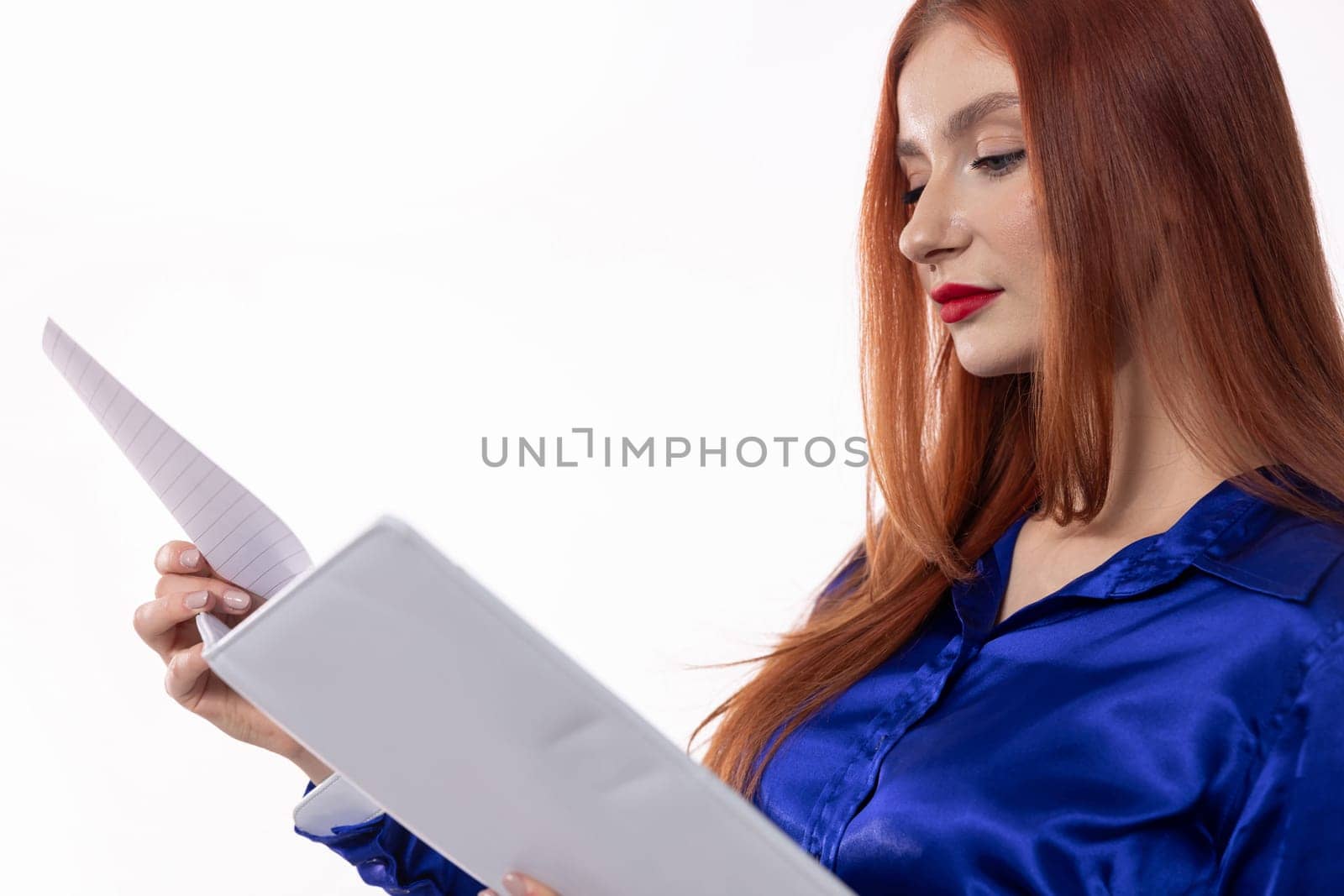 A confident woman carefully examines important documents, showcasing her elegance and professionalism with style