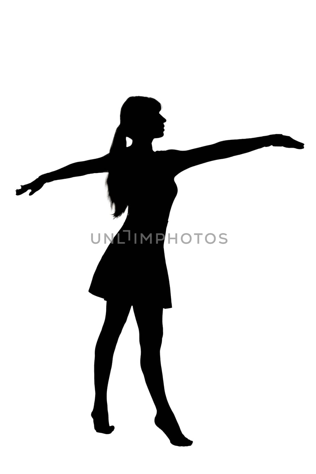 A striking silhouette of a woman standing outdoors with her arms outstretched wide to the sky, embracing the world around her