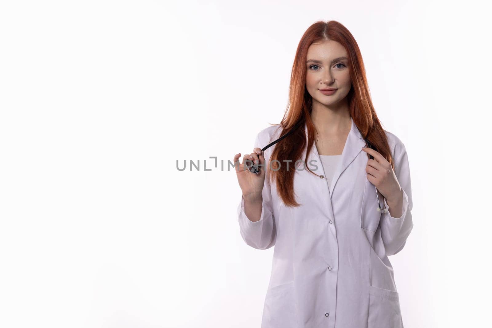 A skilled female doctor in a lab coat and stethoscope is ready to assist patients needing care and support