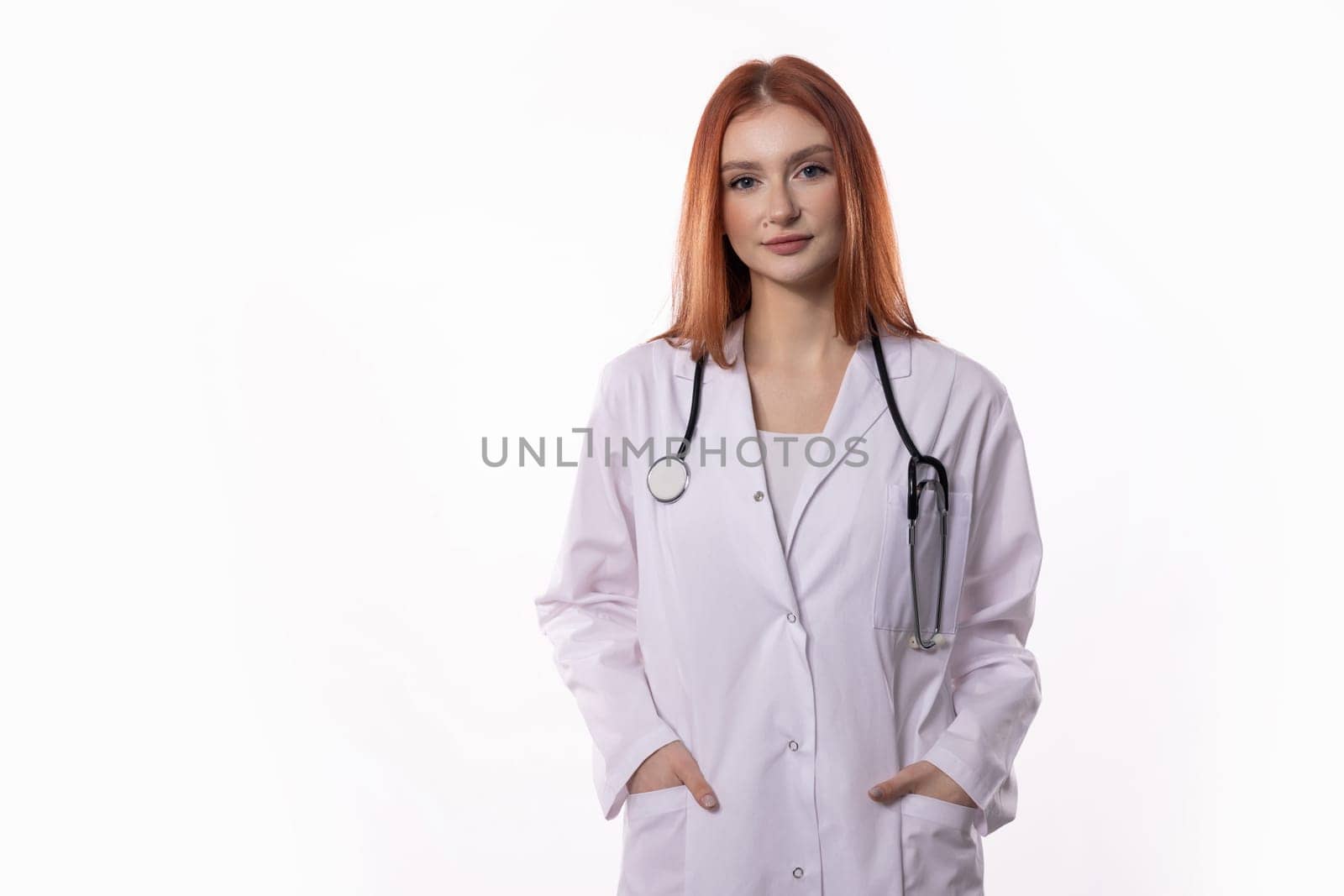 A confident female doctor in a crisp white coat and equipped with a stethoscope is fully prepared for patient care