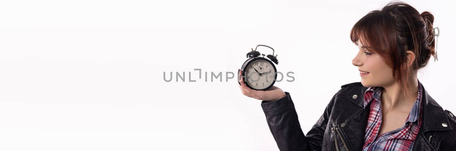 A stylish woman with a bright smile holds an alarm clock, embodying time management, elegance, and flair