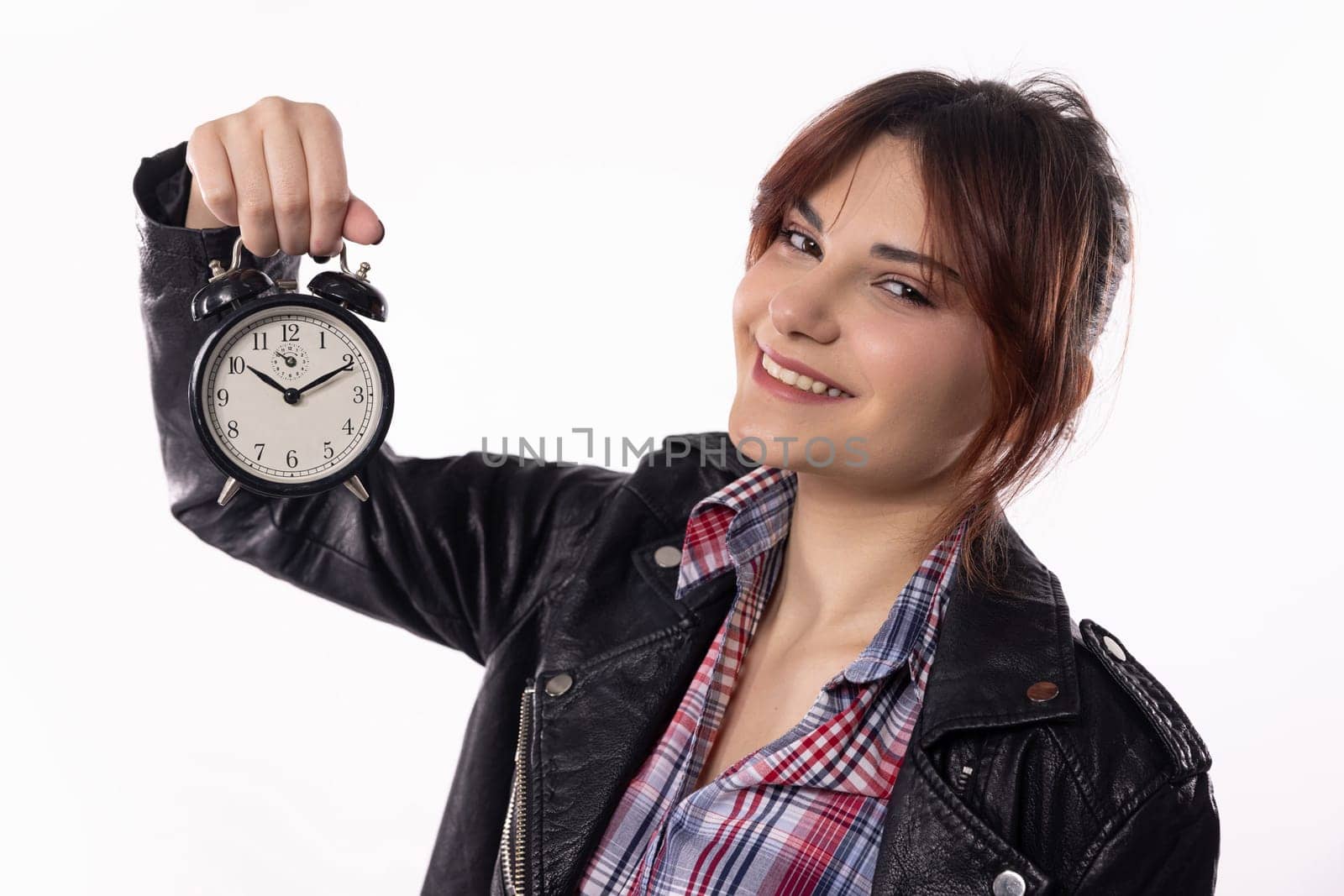 A stylish young woman holds an alarm clock, symbolizing time management and her unique personal style