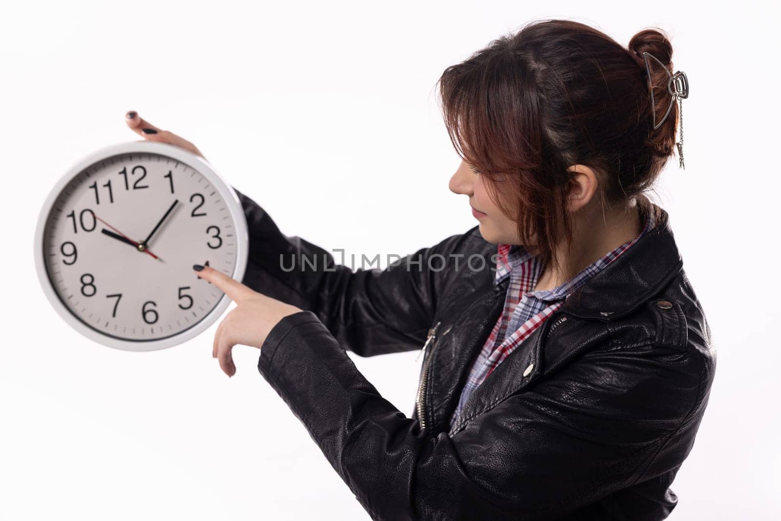 A determined woman holds a clock, emphasizing the importance of time management and punctuality in work