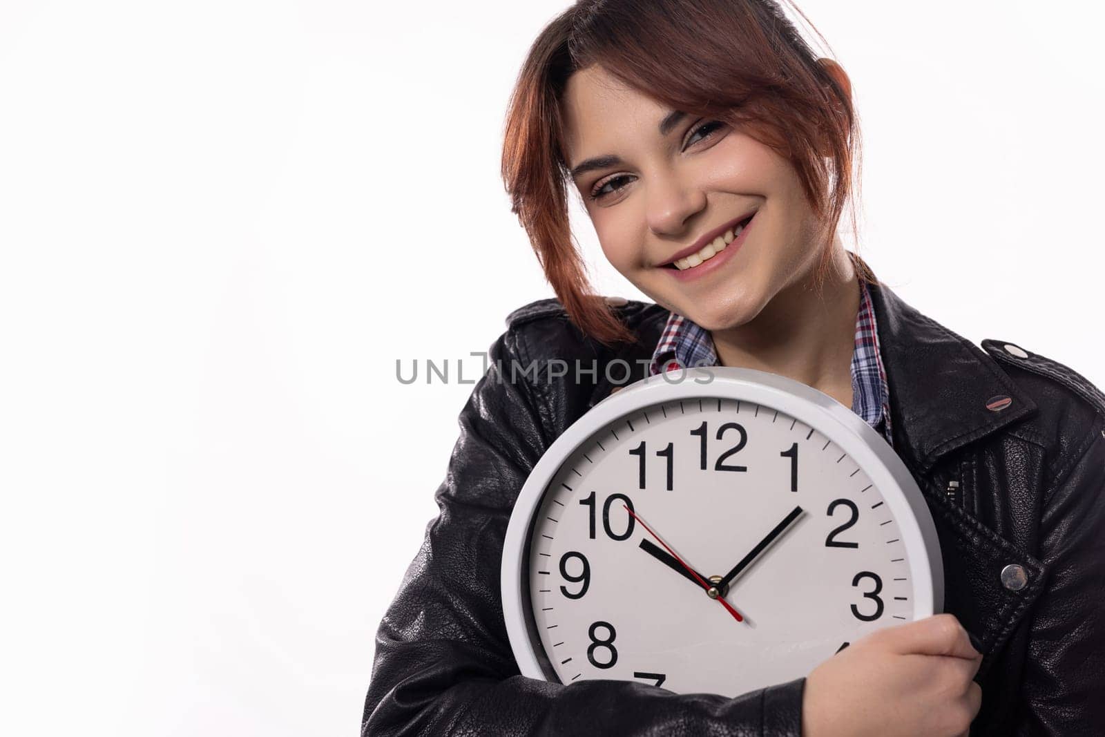 A vibrant young woman confidently poses with an elegant clock, showcasing her unique style and sense of time