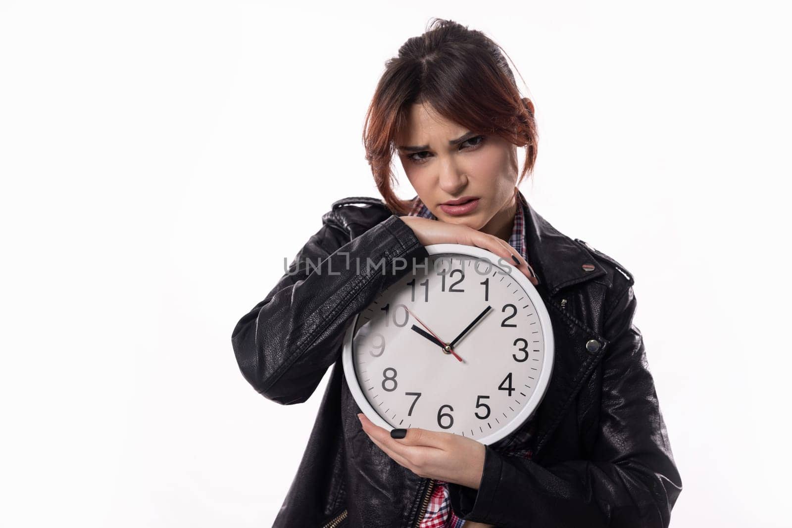A woman holding a clock has a concerned expression on her face, embodying the themes of time and stress