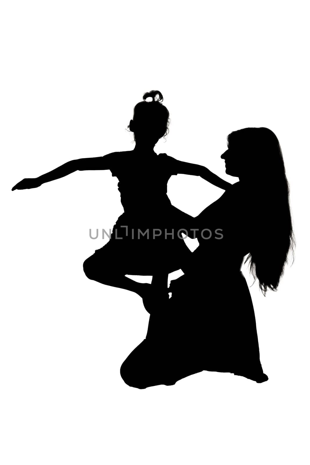 A beautiful silhouette depicting a mother and her daughter joyfully dancing together in a harmonious, artistic scene against the backdrop of nature