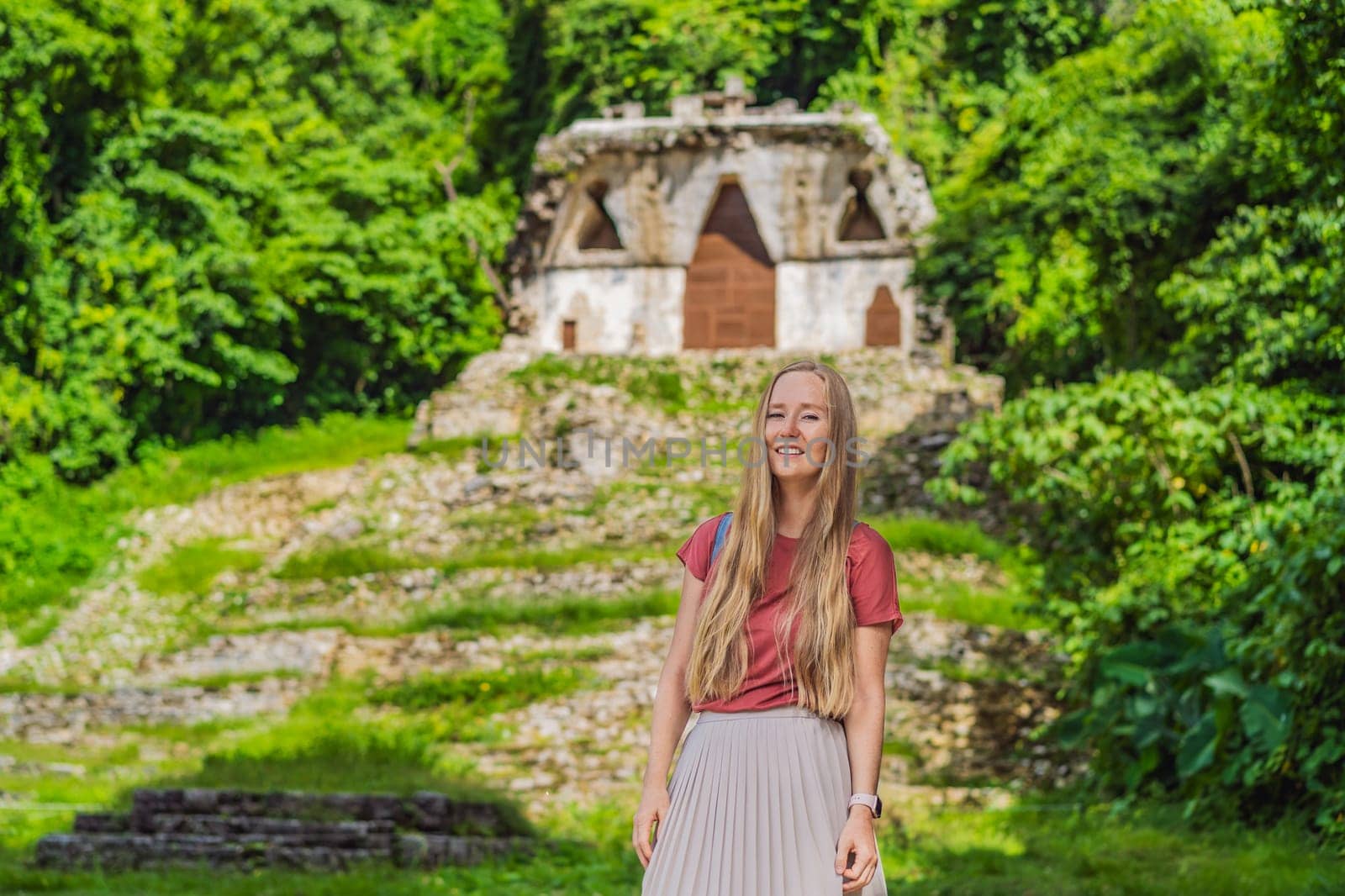 Female tourist exploring the ancient pyramids of Palenque, Mexico, surrounded by dense jungle. Cultural heritage and adventure travel concept.