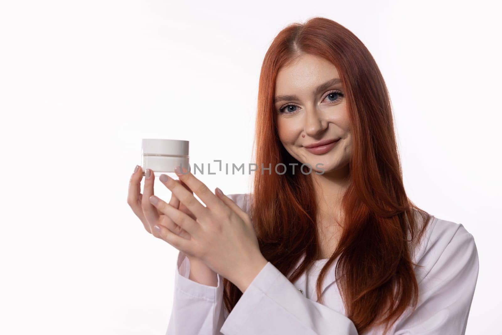 A vibrant young woman with red hair presents an innovative skincare product, emphasizing beauty and health