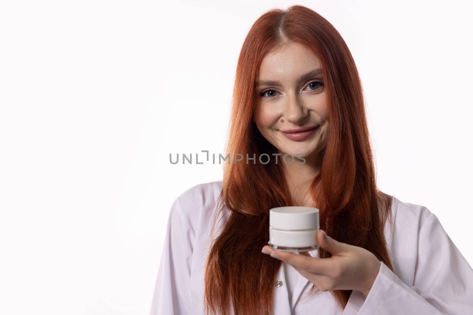 A young woman confidently and proudly showcasing a vibrant skincare product, radiating both beauty and selfassurance