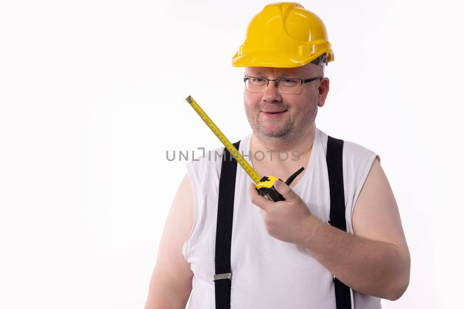 A hardworking construction worker in a bright hard hat holds a measuring tape, embodying the DIY spirit